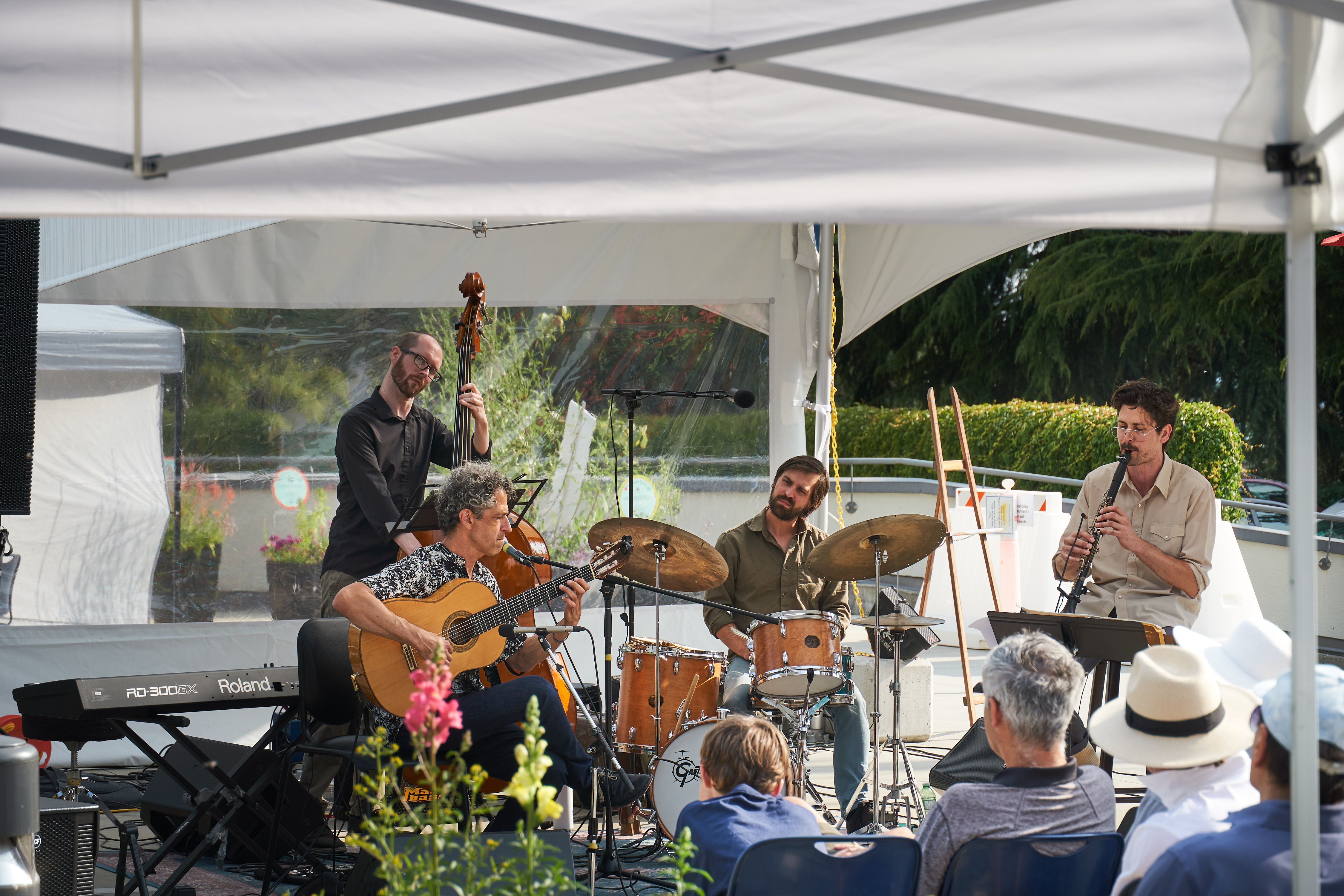 A band playing live music to an audience outdoors.